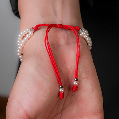 Pulsera en perla con dije de corazón